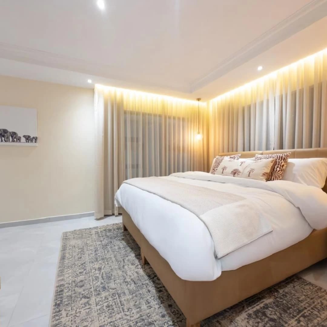 Modern bedroom with King Size Extra Length bed and warm indirect lighting